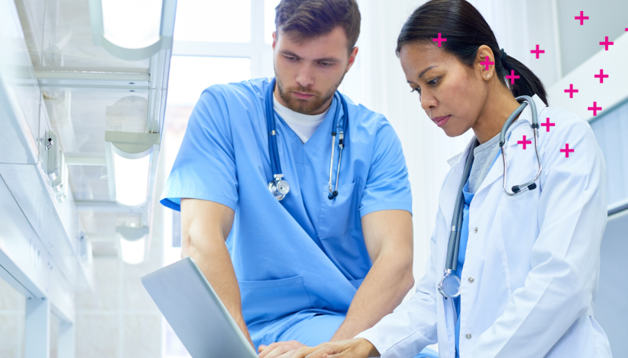 Two medical professionals looking at a laptop