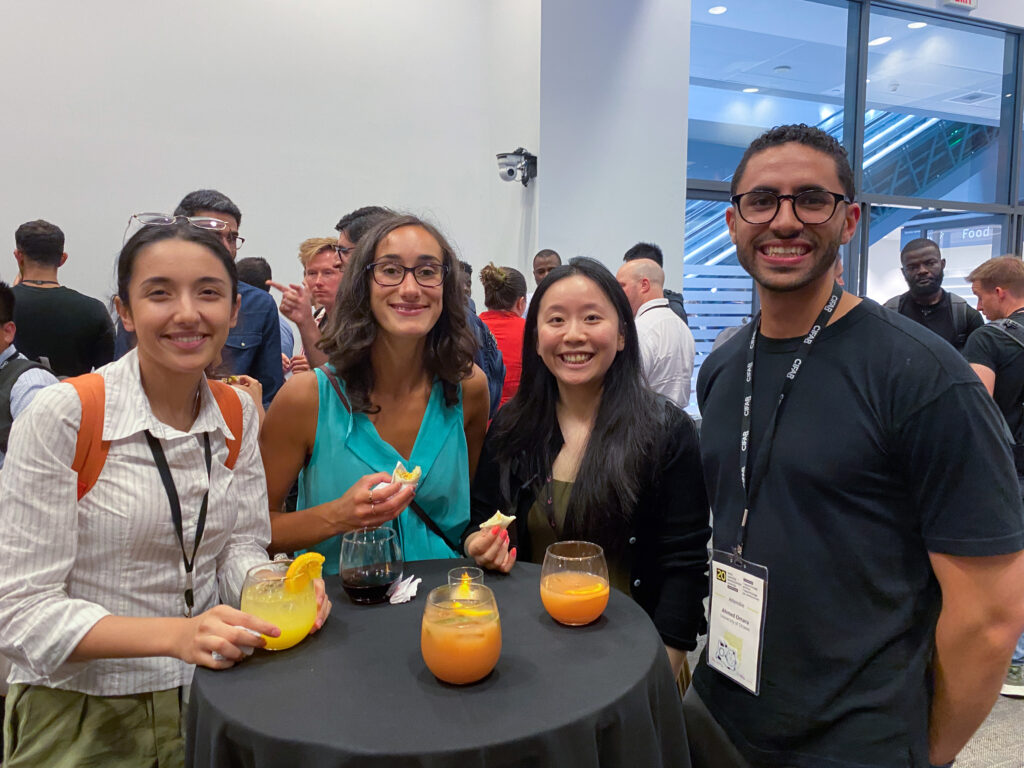 CIFAR Summer School - Image 6 - four people drinking juice - Annual Report 2024-25