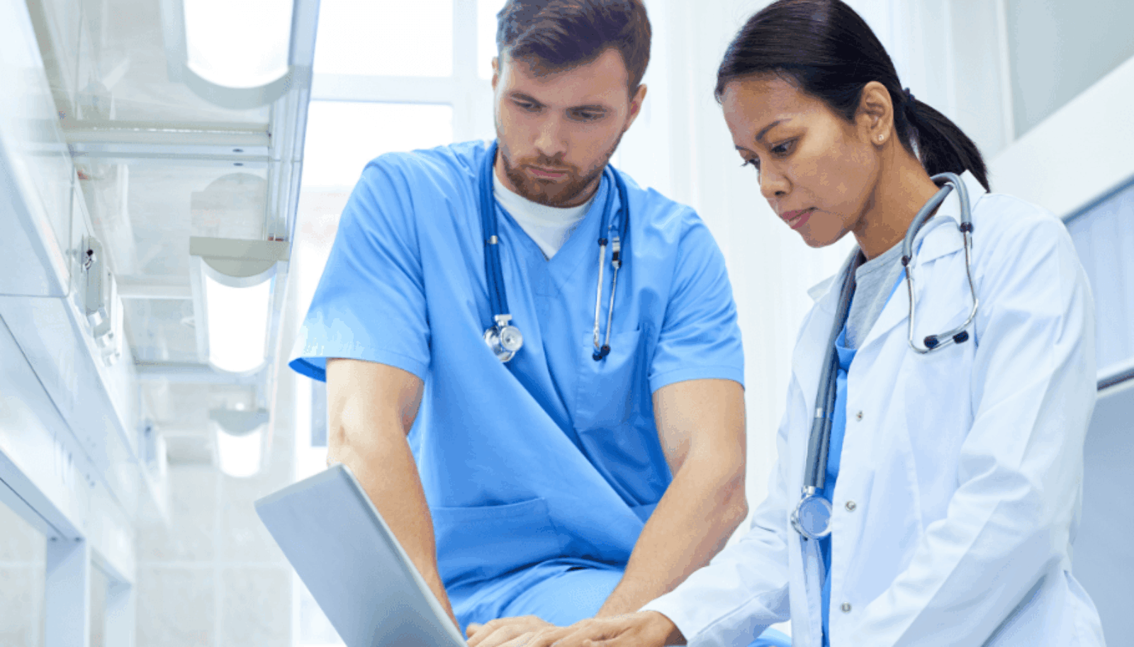 Two doctors looking at a laptop
