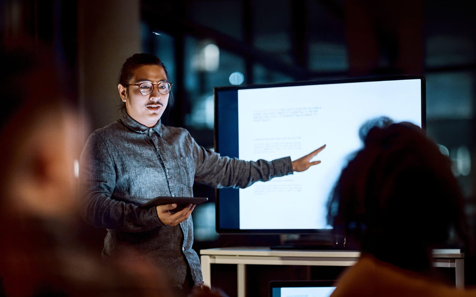 Man showcasing presentation on computer screen
